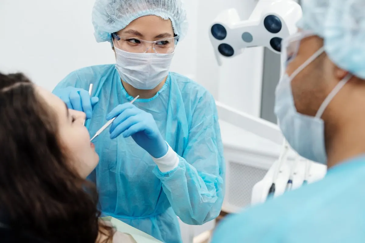 Dental hygienist performing a professional teeth cleaning and exam