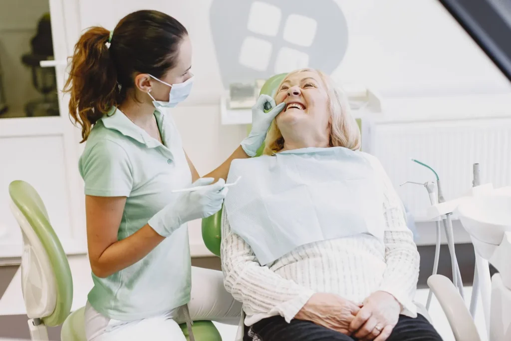 A hygienist with a patient during a dental exam and cleaning