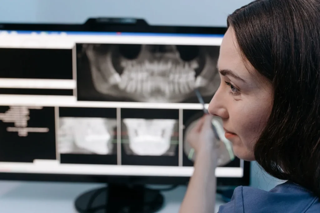 A dentist reviewing a dental X-ray