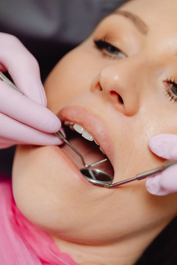A dentist examining a patient's gums and teeth