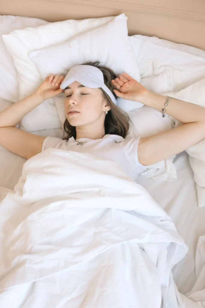 A woman resting comfortably in bed